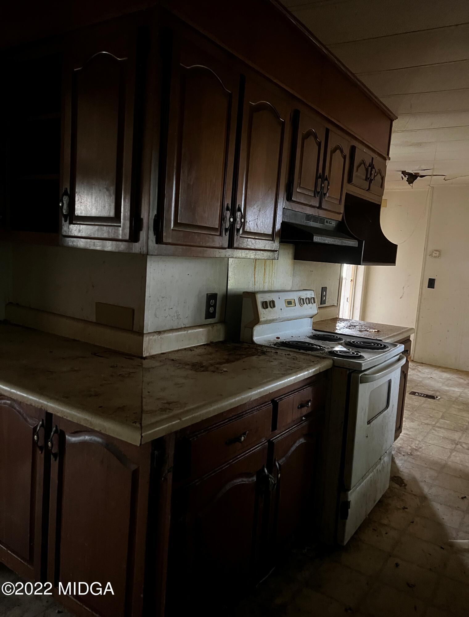6509 Skipper Road Macon, GA 31216 - Photo 16 of 28 a kitchen with stainless steel appliances granite countertop a stove and a microwave