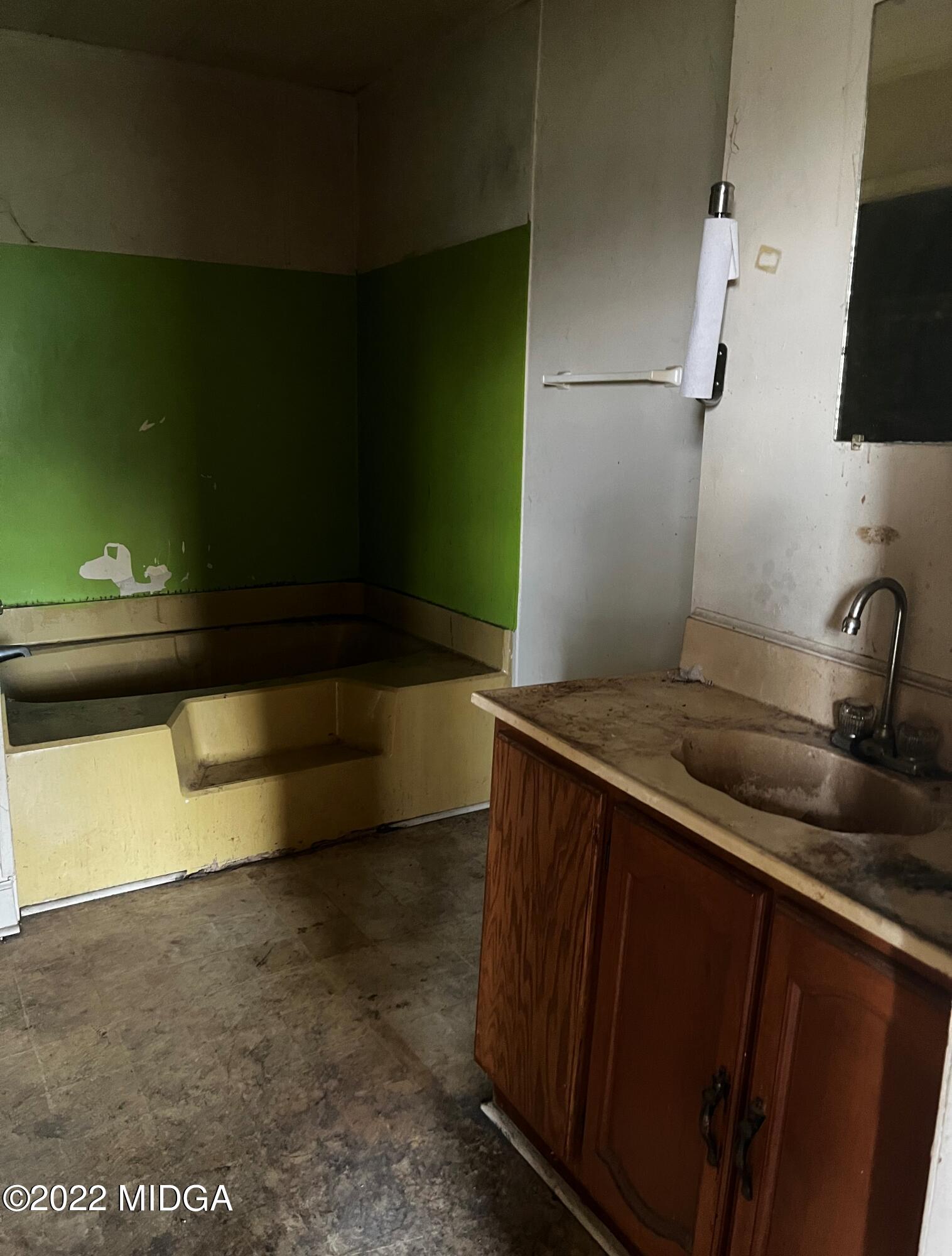 6509 Skipper Road Macon, GA 31216 - Photo 20 of 28 a kitchen with a sink and a refrigerator