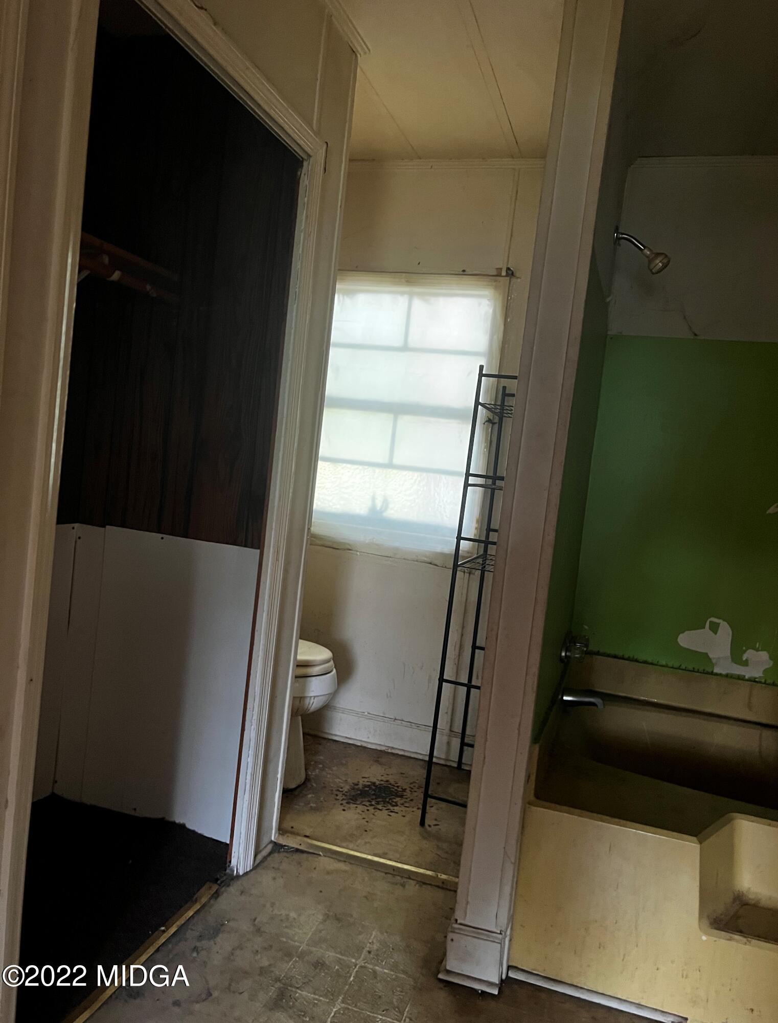 6509 Skipper Road Macon, GA 31216 - Photo 23 of 28 a bathroom with a window and a walk in closet