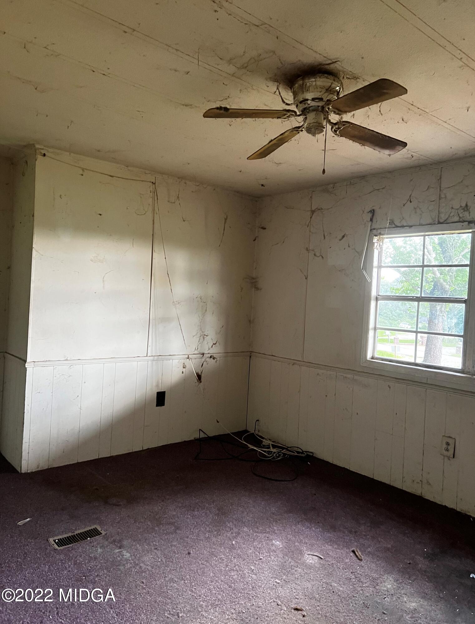 6509 Skipper Road Macon, GA 31216 - Photo 26 of 28 an empty room with a ceiling fan and window