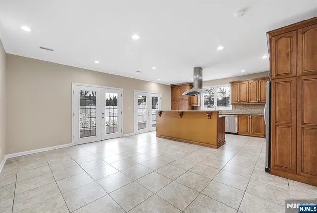 a kitchen with stainless steel appliances a refrigerator and cabinets