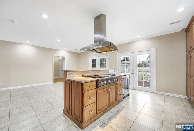 a kitchen with stainless steel appliances granite countertop a stove and a sink