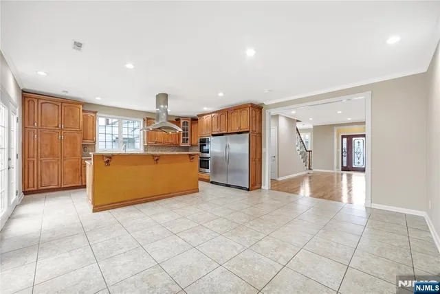 a kitchen with granite countertop a refrigerator and a sink
