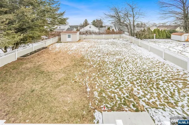 a view of a yard with a large tree