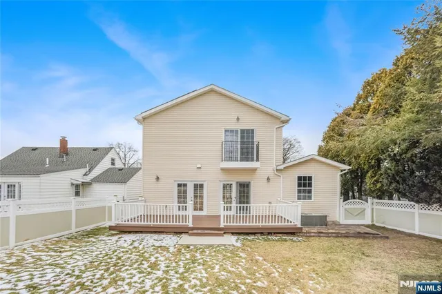 a view of a white house with a yard