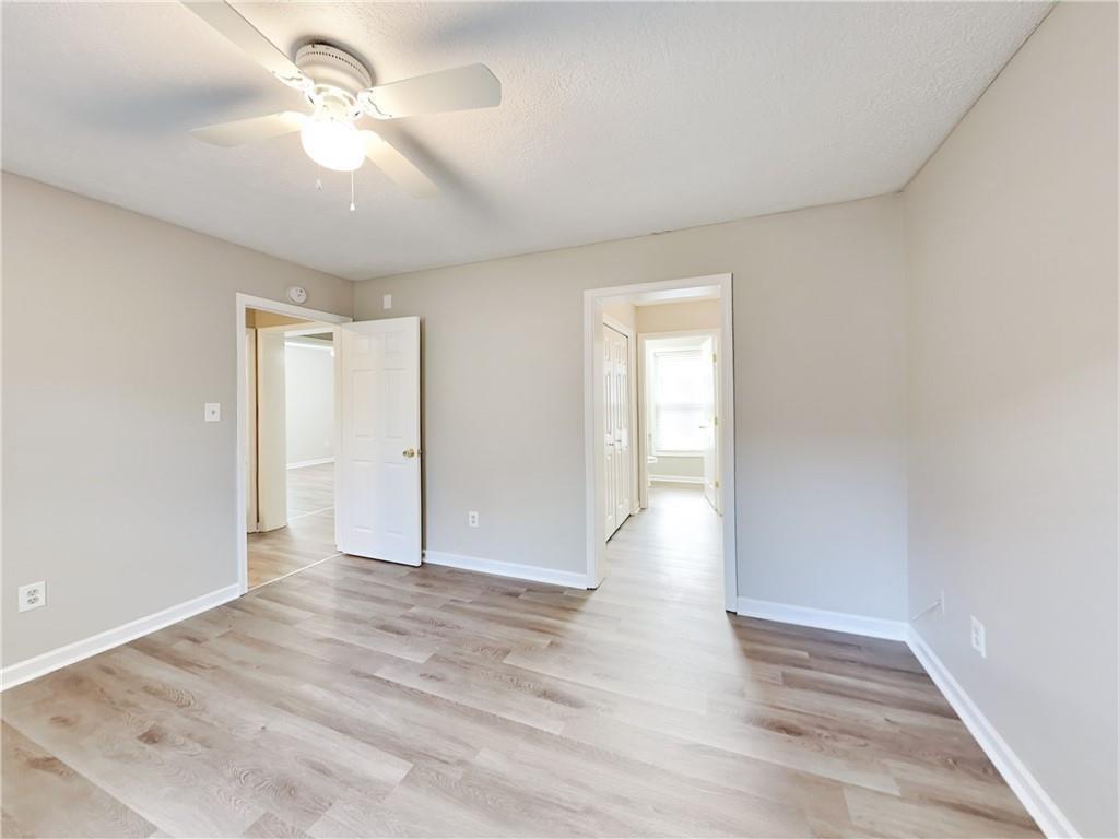 729 Cooper Street Southwest Atlanta, GA 30315 - Photo 11 of 20 a view of an empty room with a window and wooden floor
