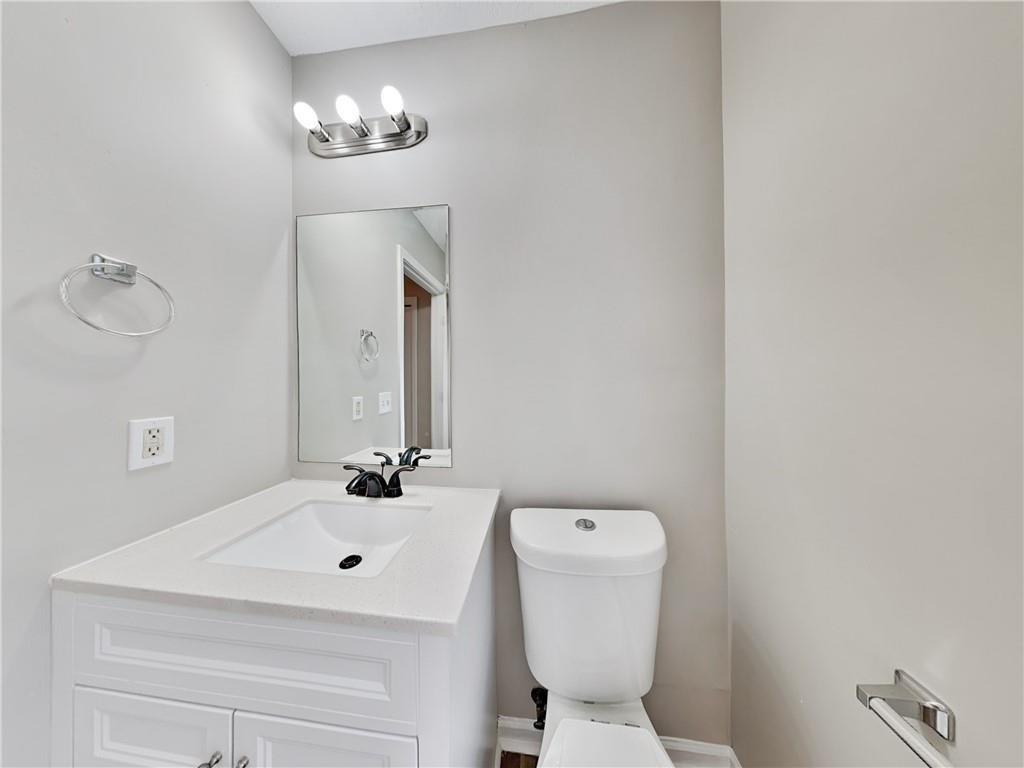 729 Cooper Street Southwest Atlanta, GA 30315 - Photo 12 of 20 a bathroom with a sink and mirror with toilet