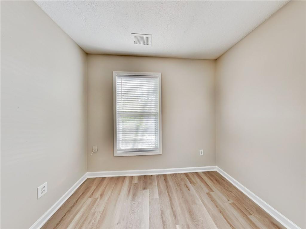 729 Cooper Street Southwest Atlanta, GA 30315 - Photo 15 of 20 an empty room with wooden floor and windows