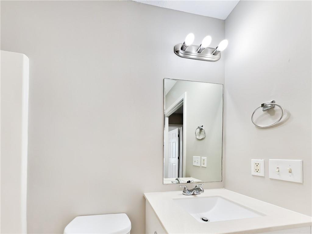 729 Cooper Street Southwest Atlanta, GA 30315 - Photo 18 of 20 a bathroom with a toilet a sink and mirror