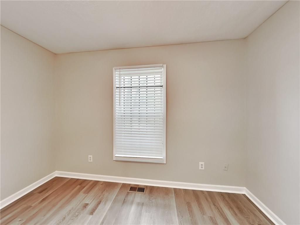 729 Cooper Street Southwest Atlanta, GA 30315 - Photo 9 of 20 an empty room with wooden floor and windows