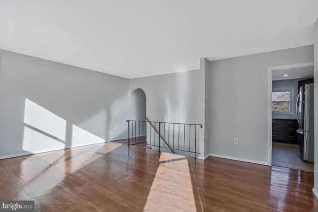 a view of staircase with white walls and railing
