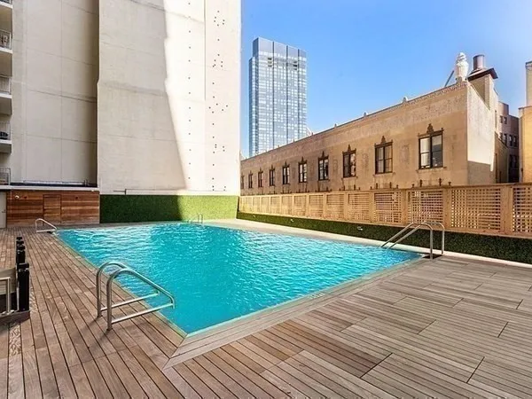 a view of a balcony with wooden floor and fence