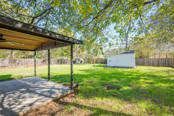 a view of a backyard with a garden and trees