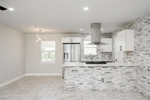 a kitchen with stainless steel appliances kitchen island granite countertop a sink and cabinets