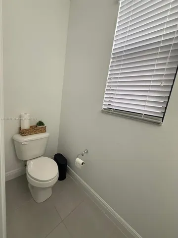 a white toilet sitting next to a white sink