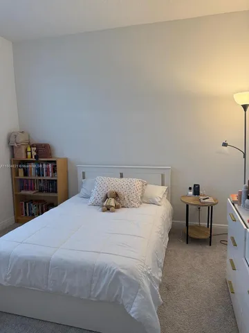 a bedroom with a bed and a bookshelf