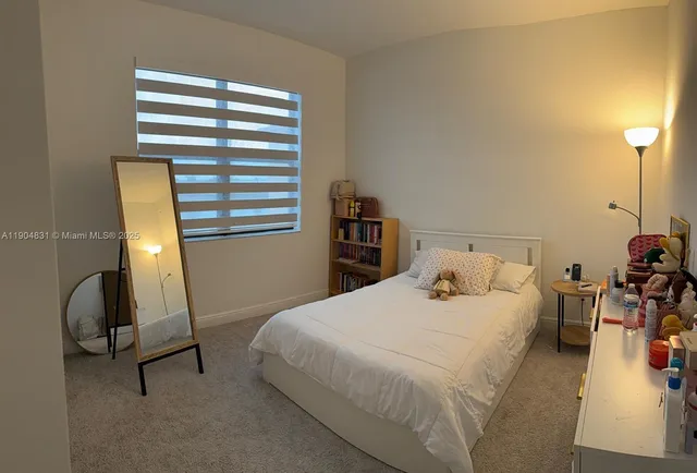 a bedroom with a bed a desk and chair