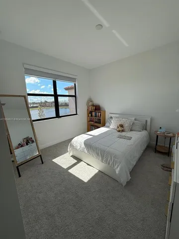 a bedroom with bed and window