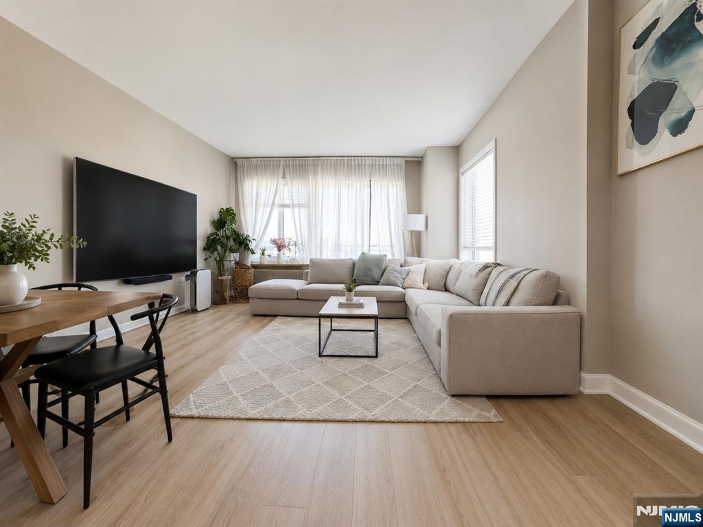 3418 City Place, Unit 3418 Edgewater, NJ 07020 - Photo 1 of 10 a living room with furniture and a flat screen tv