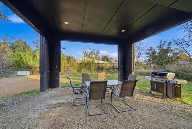 a view of a field with trees in the background