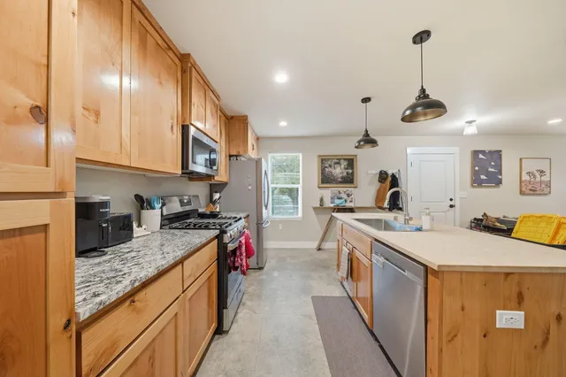 a kitchen that has a lot of cabinets in it