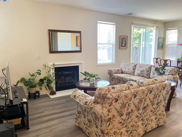 a living room with furniture windows and a fireplace