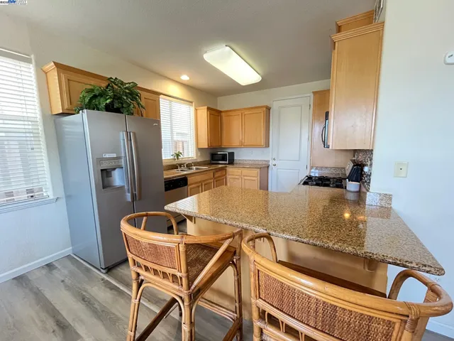 a kitchen with a refrigerator a stove a sink and a counter top space
