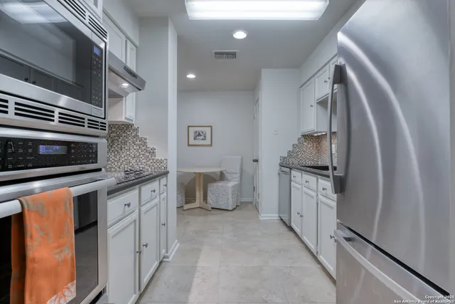 a view of cabinets and wooden floor
