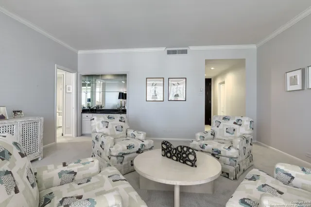 a bedroom with furniture and a large window