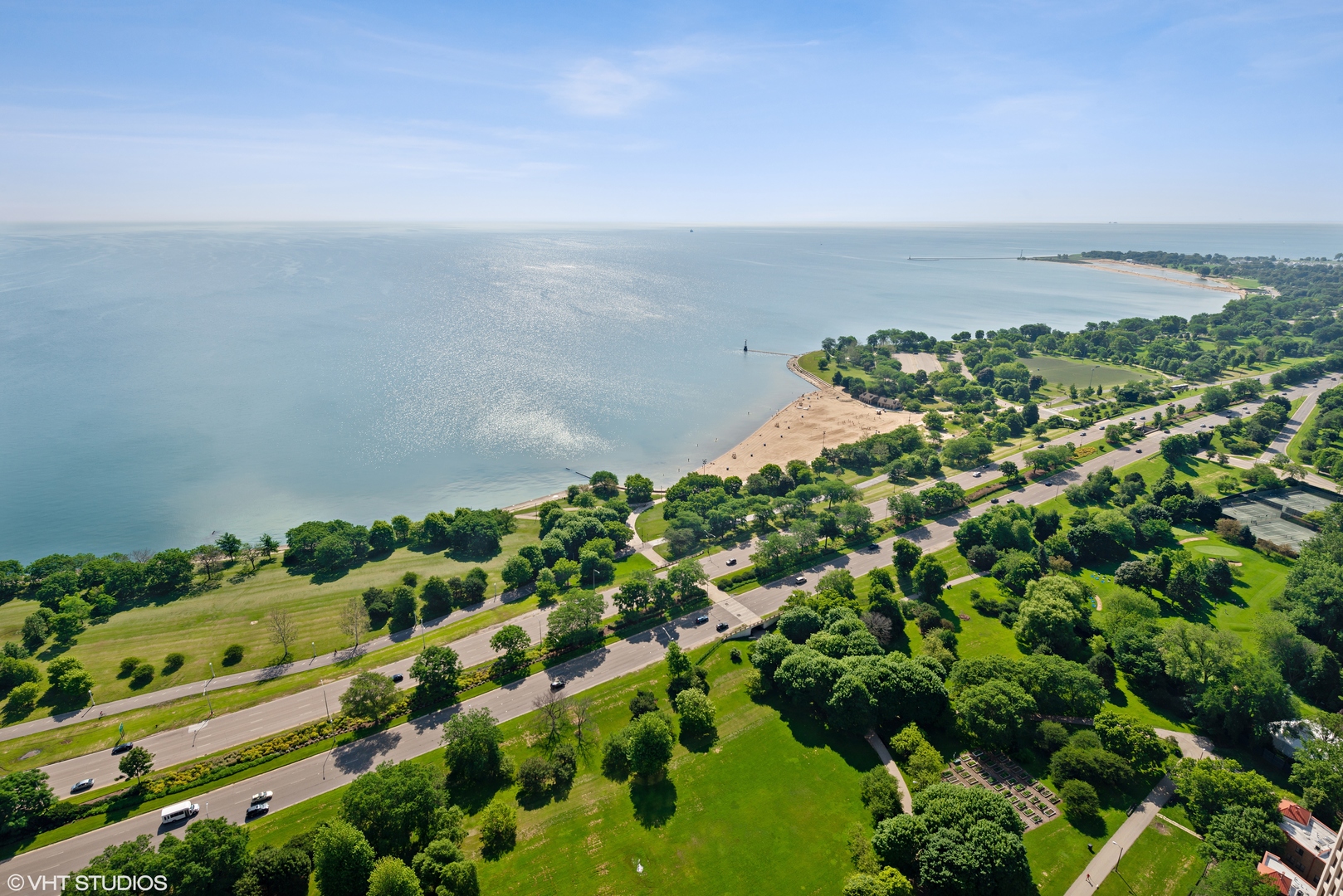 5415 North Sheridan Road, Unit 5305 Chicago, IL 60640 - Photo 11 of 16 an aerial view of a city with lots of residential buildings in back and covered with trees