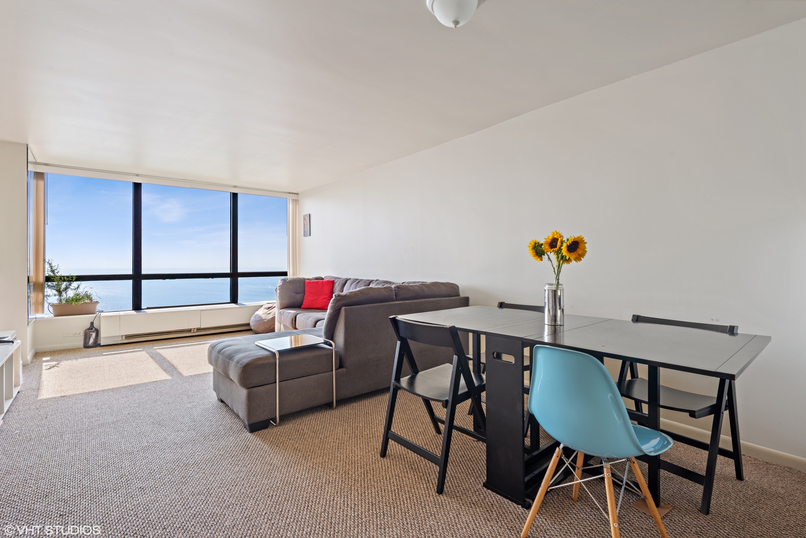 5415 North Sheridan Road, Unit 5305 Chicago, IL 60640 - Photo 4 of 16 a living room with furniture and a wooden floor