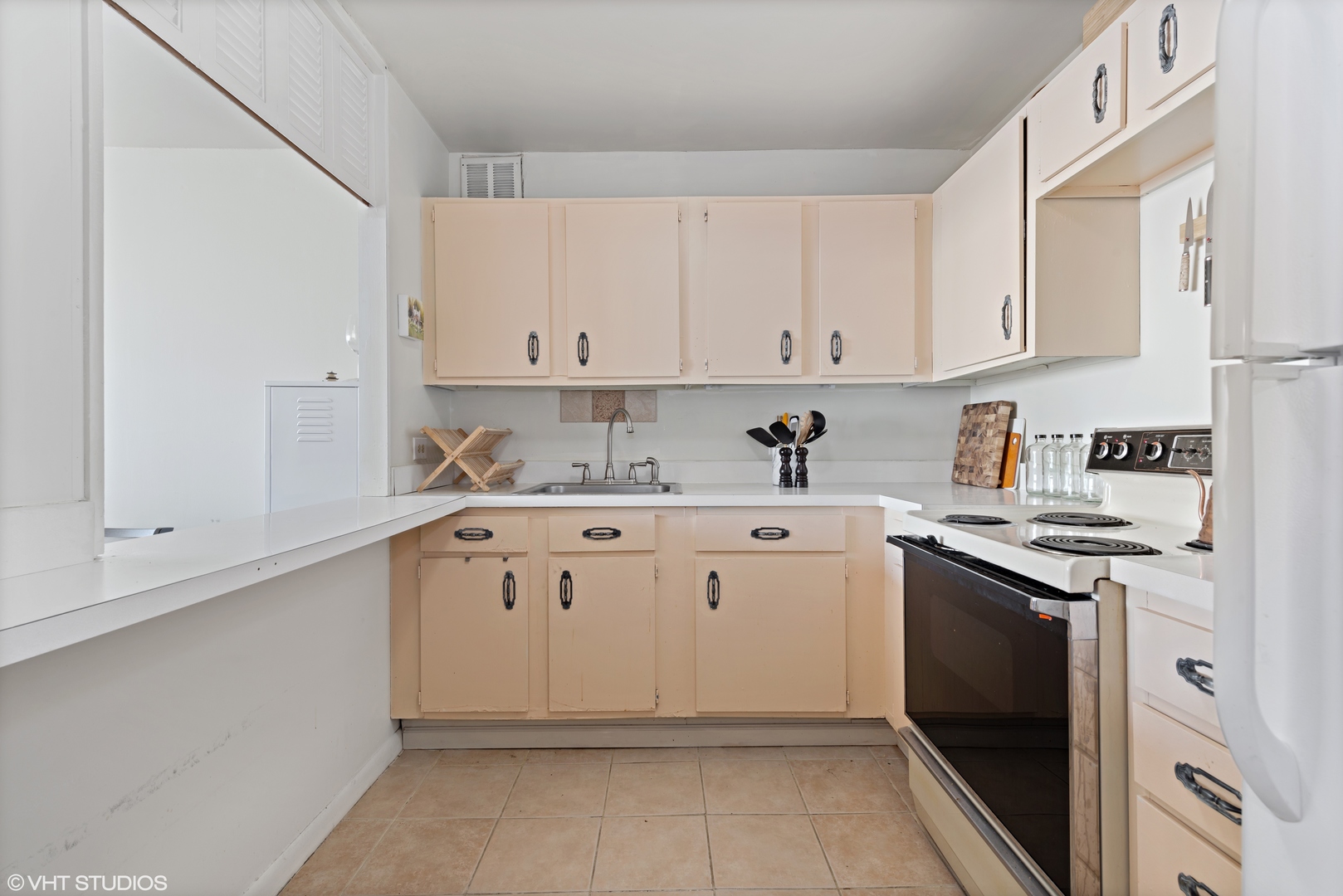 5415 North Sheridan Road, Unit 5305 Chicago, IL 60640 - Photo 5 of 16 a kitchen with granite countertop white cabinets and white appliances