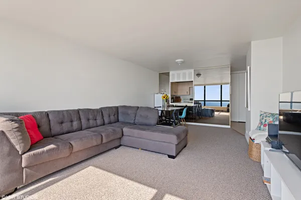 a living room with furniture white walls and a couch