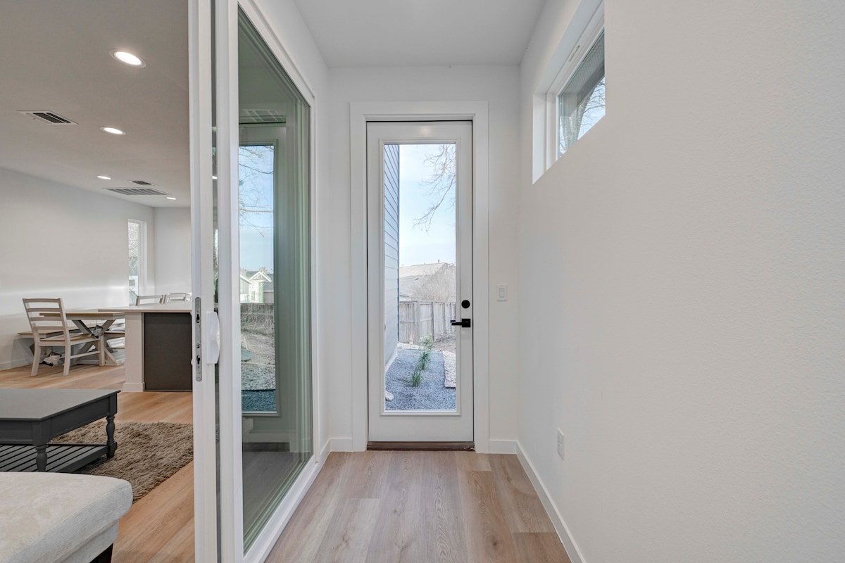 2220 Yellow Jacket Lane, Unit 1 Austin, TX 78741 - Photo 10 of 35 A well-lit entry hall with wood flooring and direct access to an outdoor area.