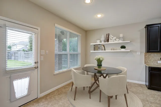 a dining room with furniture and window