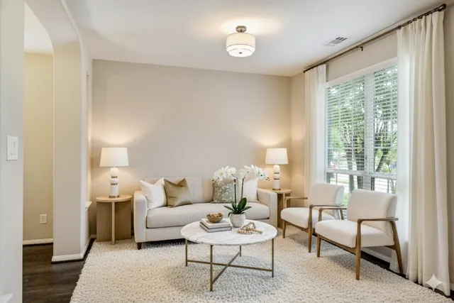 a living room with furniture and a large window