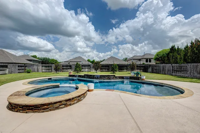 a view of swimming pool with seating space
