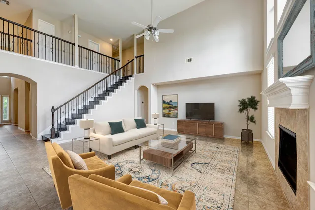 a living room with furniture flat screen tv and a fireplace