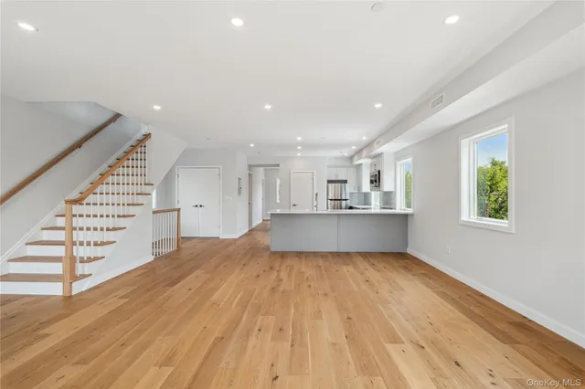a view of a kitchen with wooden floor and staircase