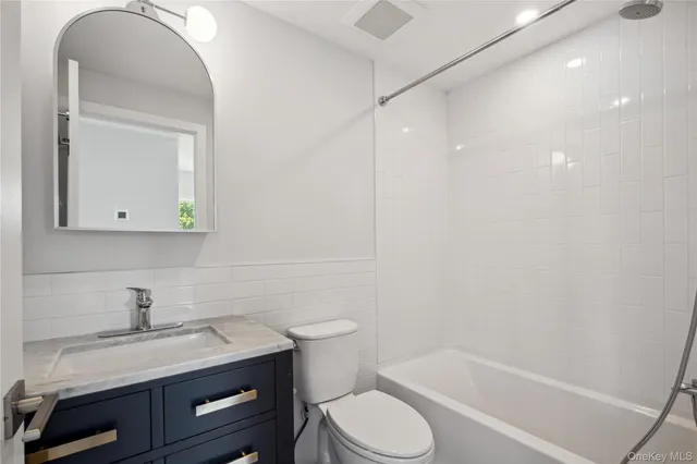 a view of a kitchen with wooden floor refrigerator and windows