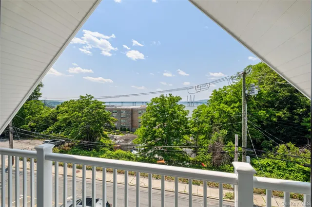 a view of a balcony with wooden floor