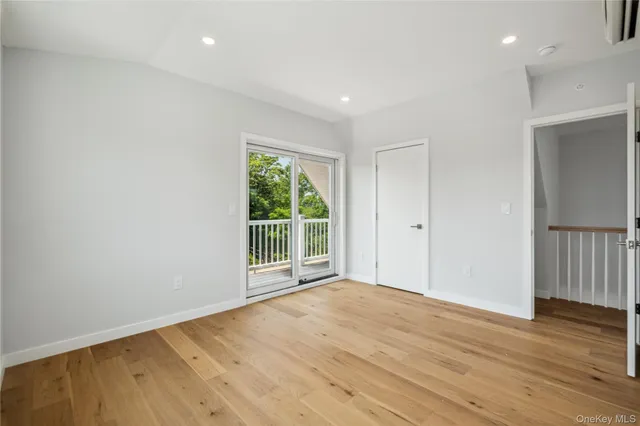 a large kitchen with stainless steel appliances granite countertop a large center island and a wooden floors