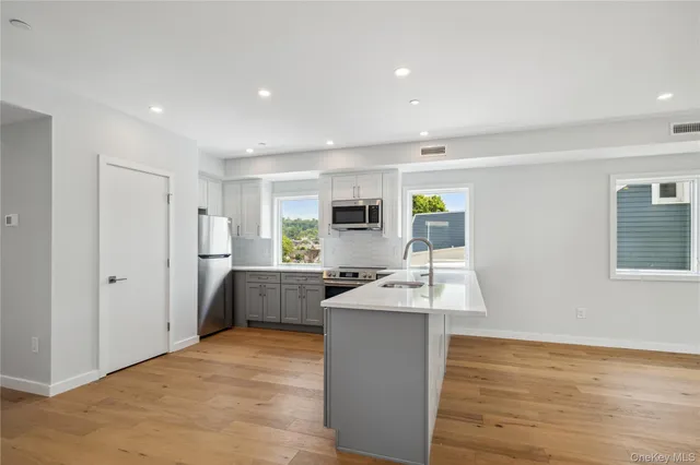 a kitchen with sink cabinets and wooden floor
