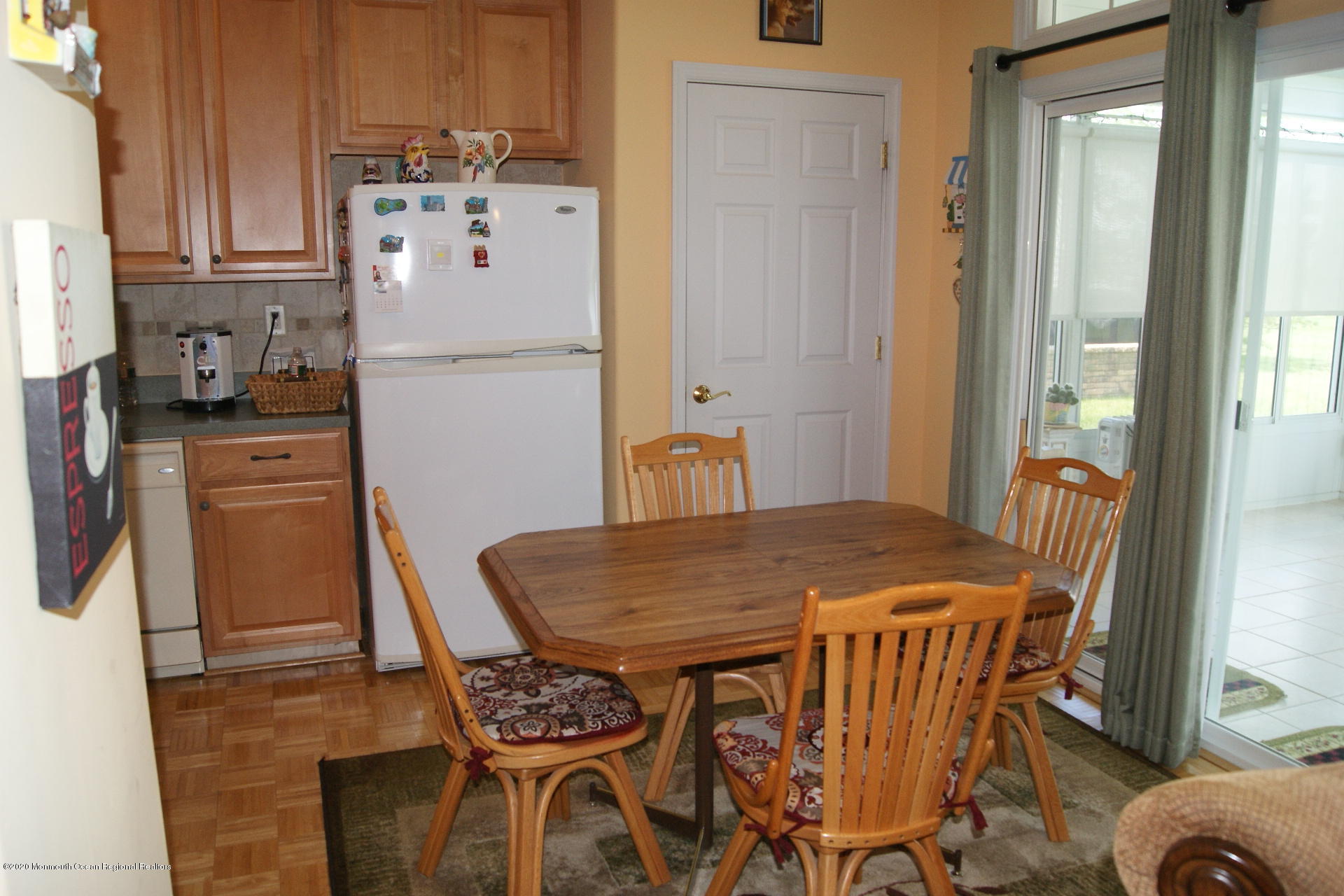 9 Bellagio Road Manchester Township, NJ 08759 - Photo 25 of 37 a kitchen with a table chairs and refrigerator