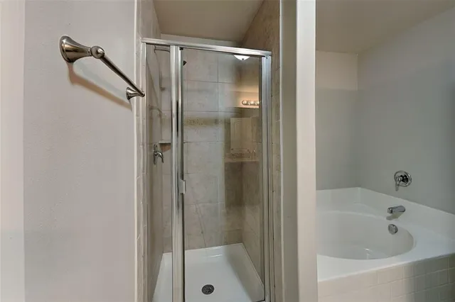 a bathroom with a bathtub and shower
