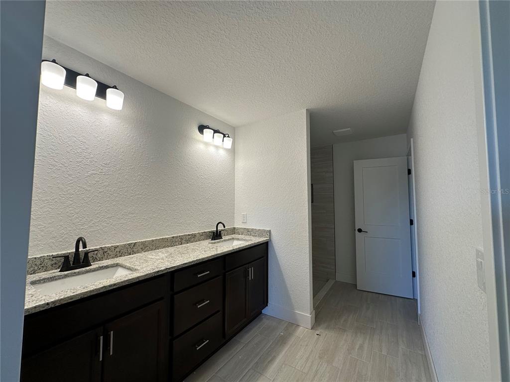 4546 Southwest 90th Ln Road Ocala, FL 34476 - Photo 5 of 9 a bathroom with a double vanity sink and mirror