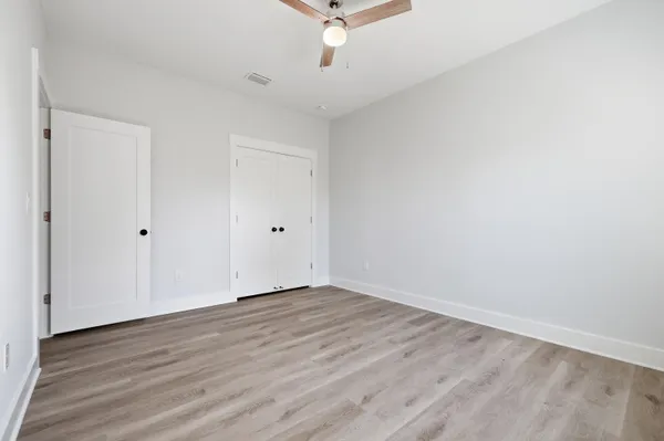 a view of a hallway with wooden floor