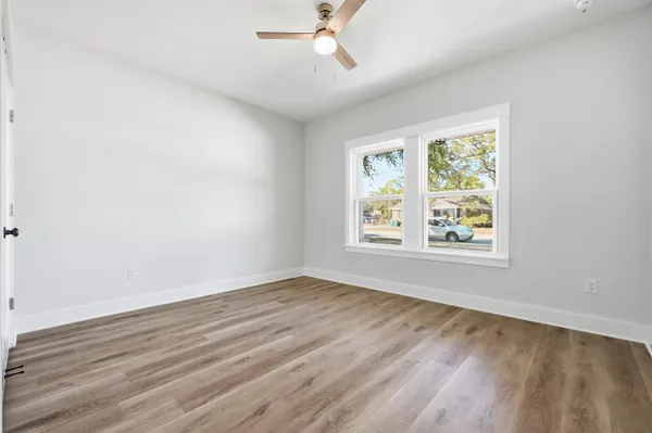 wooden floor in an empty room with a window