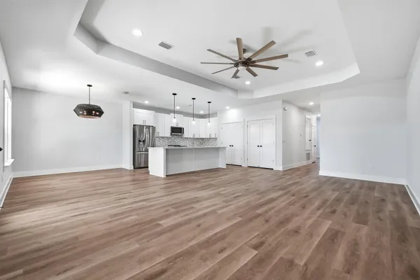 a view of a room with wooden floor