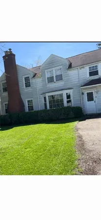 a view of house with backyard